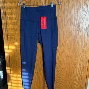 Navy Blue High-Waisted Leggings with side pockets. Size Medium brand new tags.